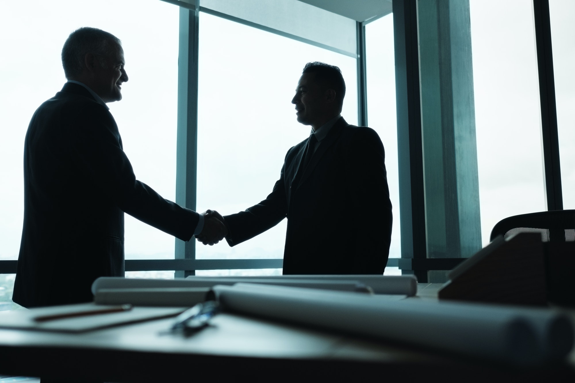 Manager Shaking Hands of Business Partner In Meeting Room
